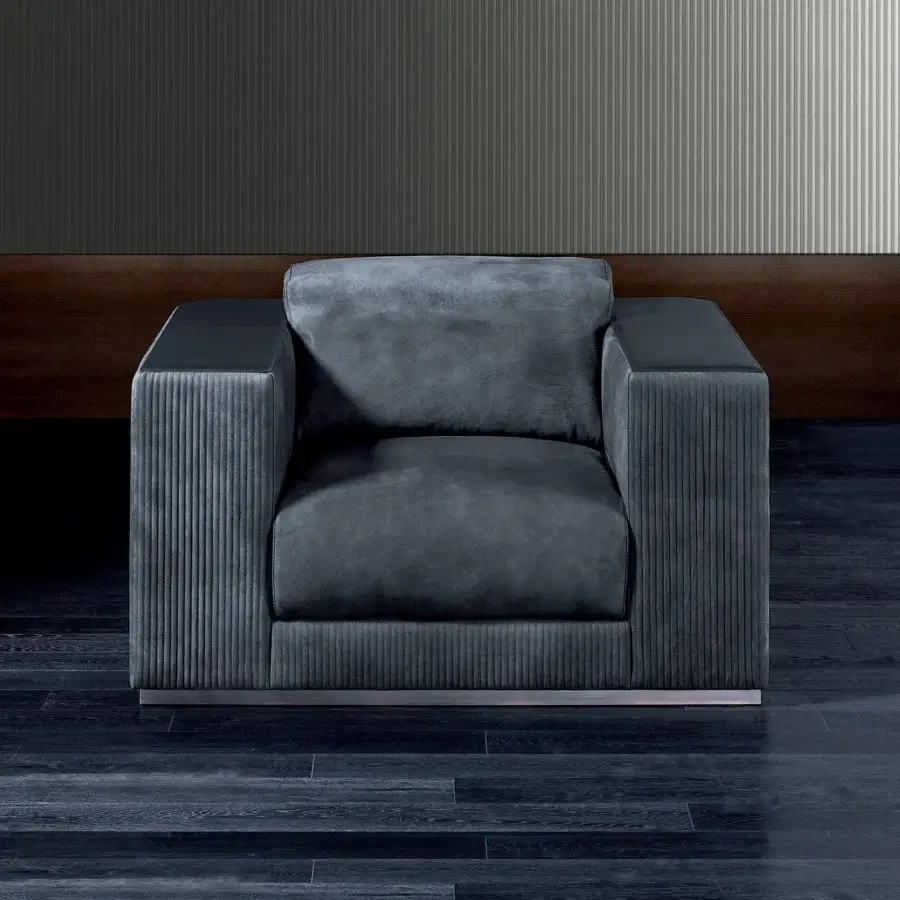 Lavish Rugiano Vogue lounge chair with dark gray-blue textured fabric upholstery and subtly-sheened arms built with a brushed steel base