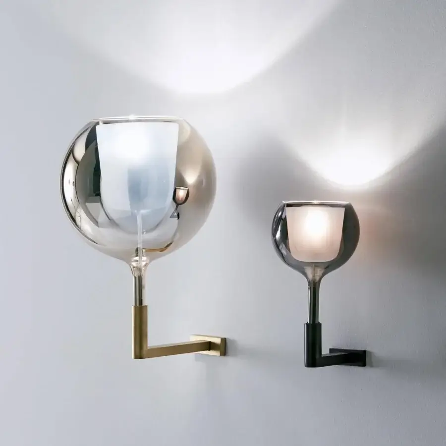 Exceptional Penta Glo wall lamp with brass-toned metal structure and refined mirrored glass shade with glossy finish