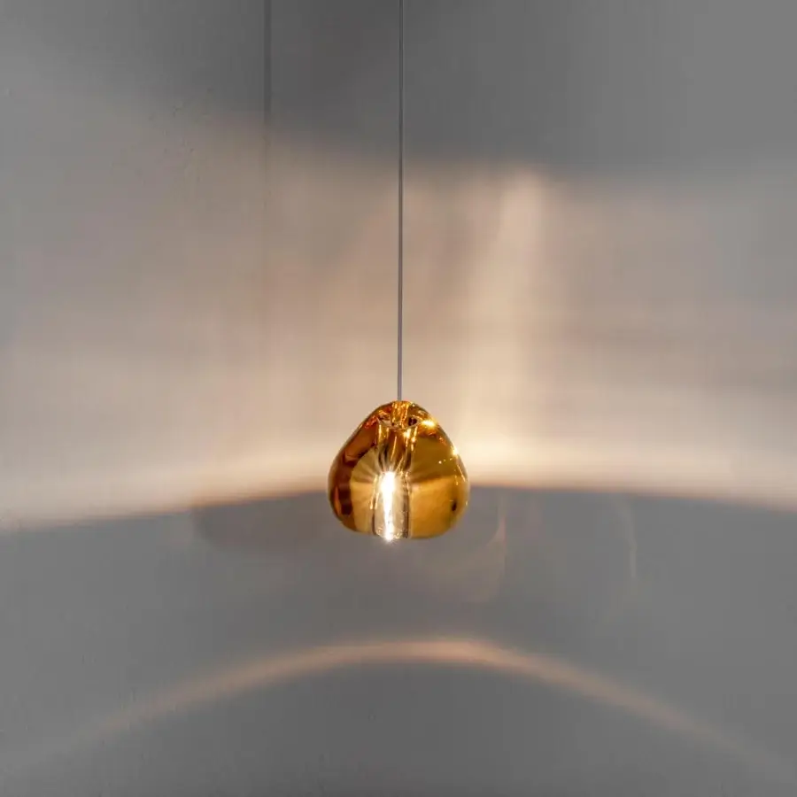 Exquisite Terzani Mizu suspension lamp crafted in crystal with a glossy finish exhibiting a warm golden-amber hue