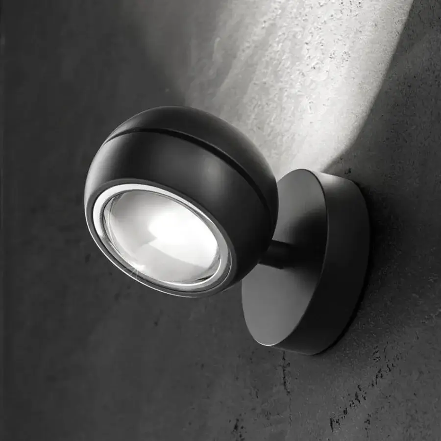 Elegant Lodes Nautilus Mini wall lamp crafted in metal with a matte dark gray finish illuminating with balanced directional light