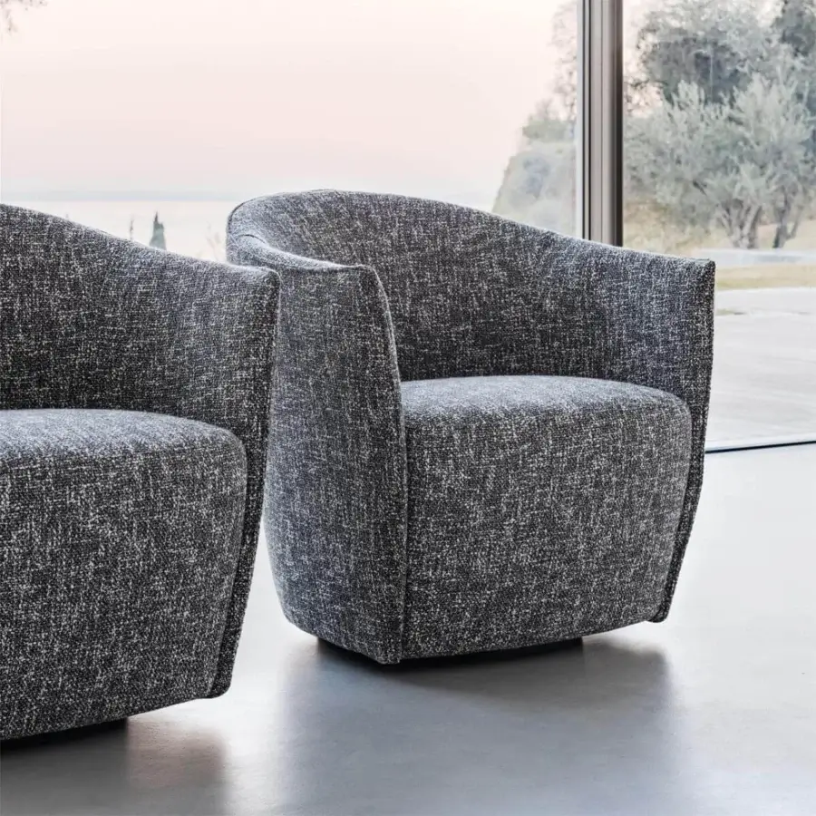 Sophisticated Presotto Fuller lounge chair with dark gray textured fabric upholstery and fully upholstered swiveling base