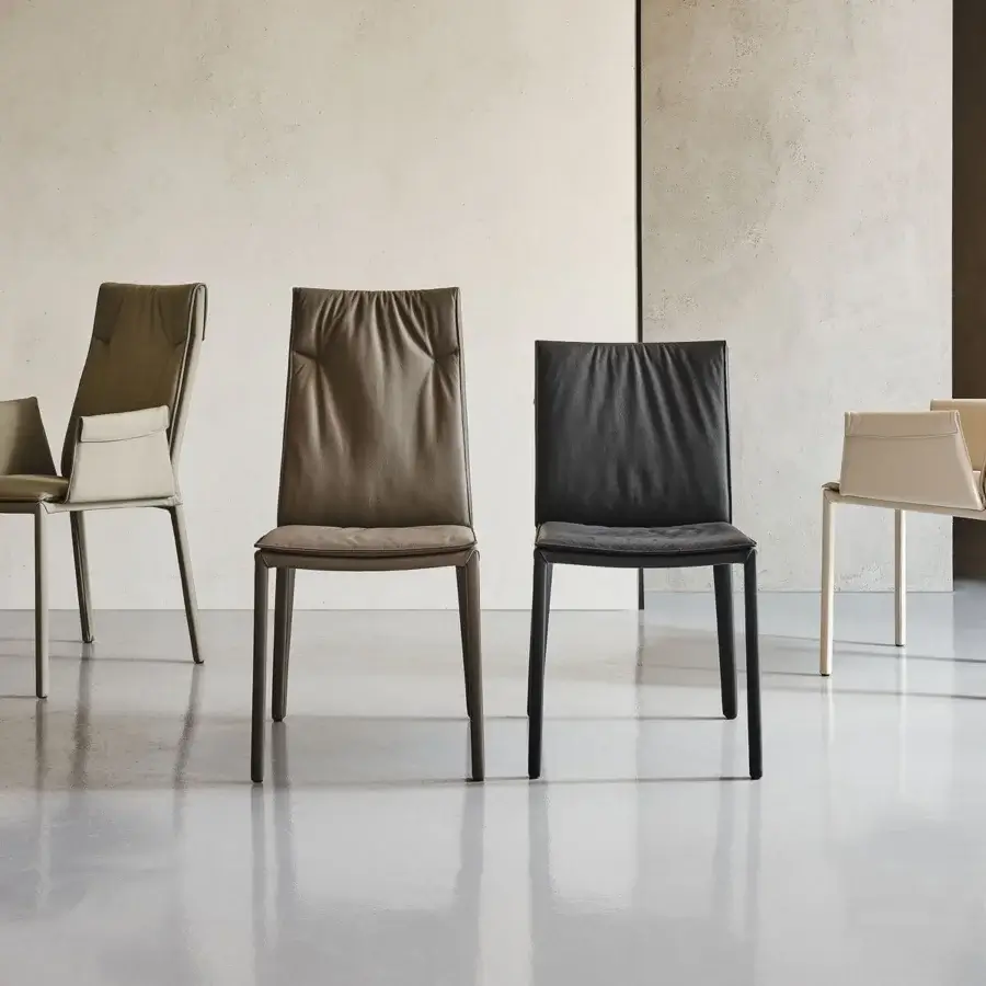 Elegant Cattelan Italia Isabel chair with a tall silhouette, light olive-green textile upholstery and slender steel legs