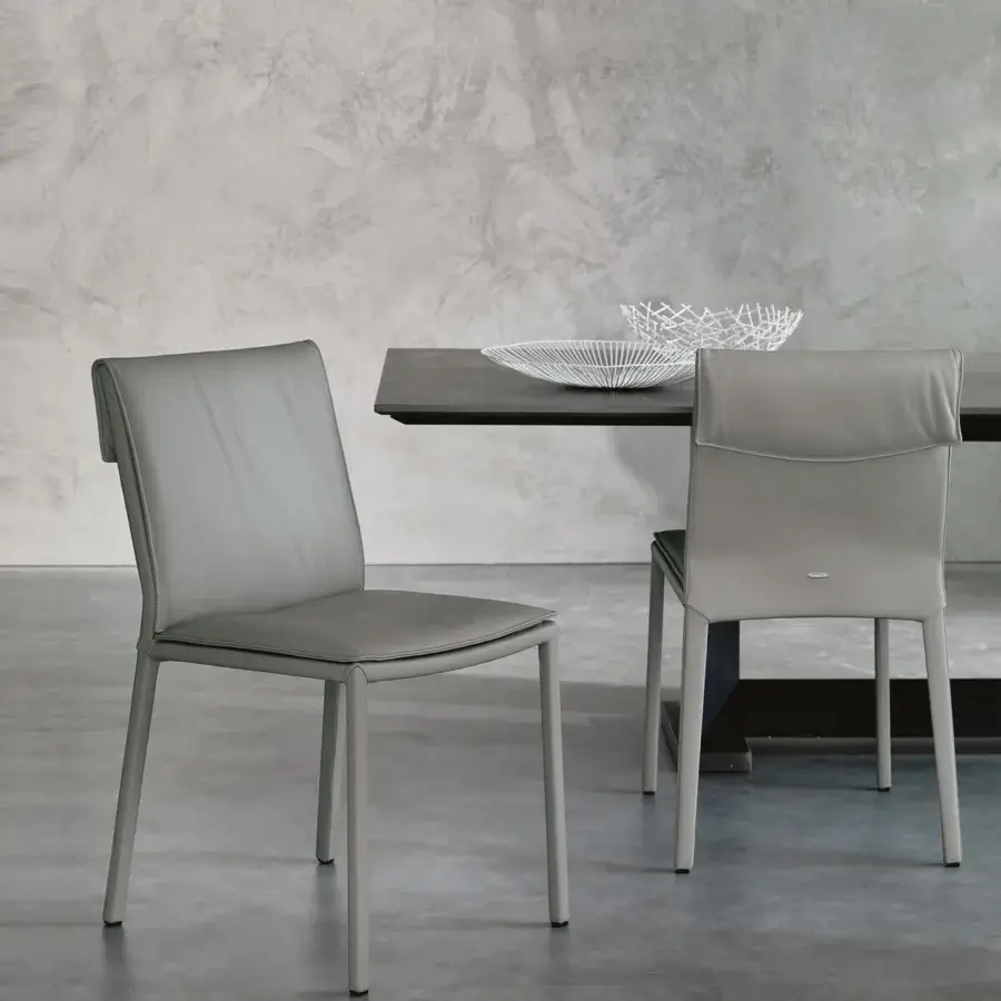 Superior Cattelan Italia Isabel chair in light gray leather with slender exposed steel legs and enveloping backrest