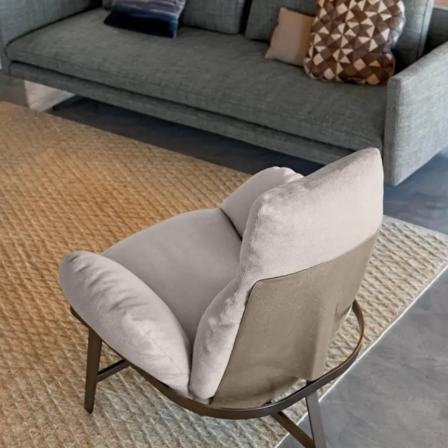 Elegant Arketipo Jupiter lounge chair with a light beige textile and dark metal frame supporting a glass fibre shell