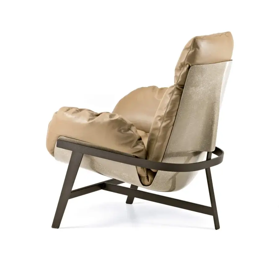 Lavish Arketipo Jupiter Lite lounge chair with a shell covered in light tan Pelle Leonardo leather and dark bronze metal structure