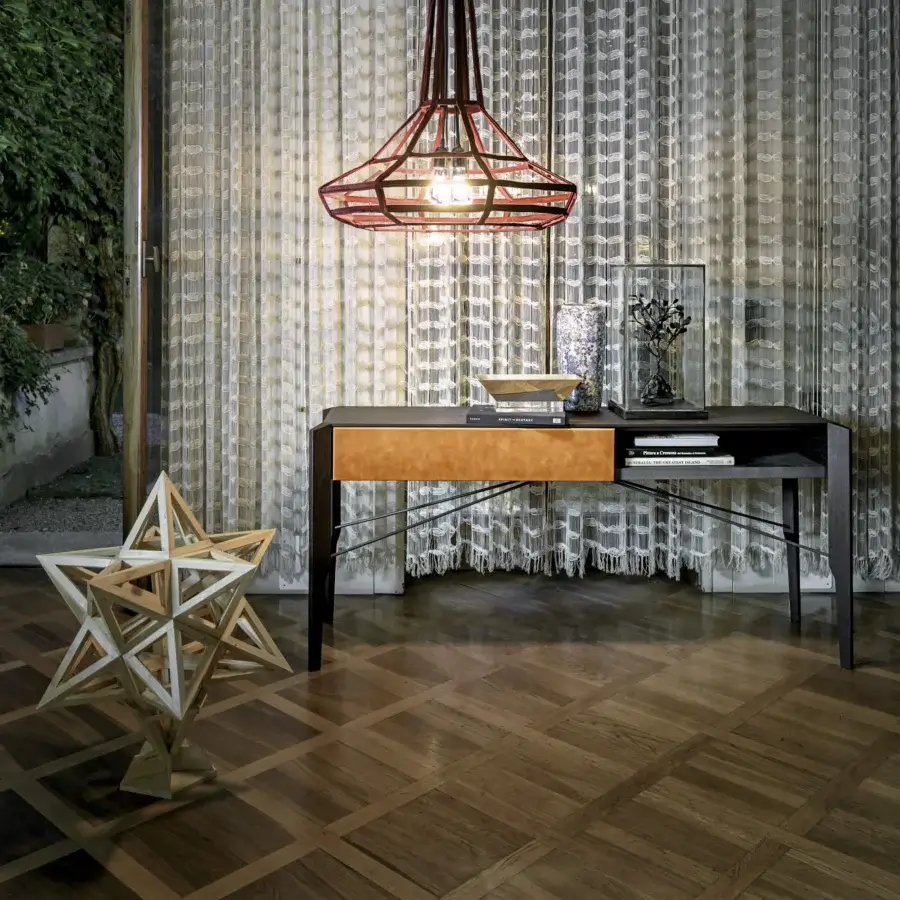 Sophisticated Arketipo Glory console built with a dark gray frame, streamlined metal supports, and a single orange Leonardo leather drawer
