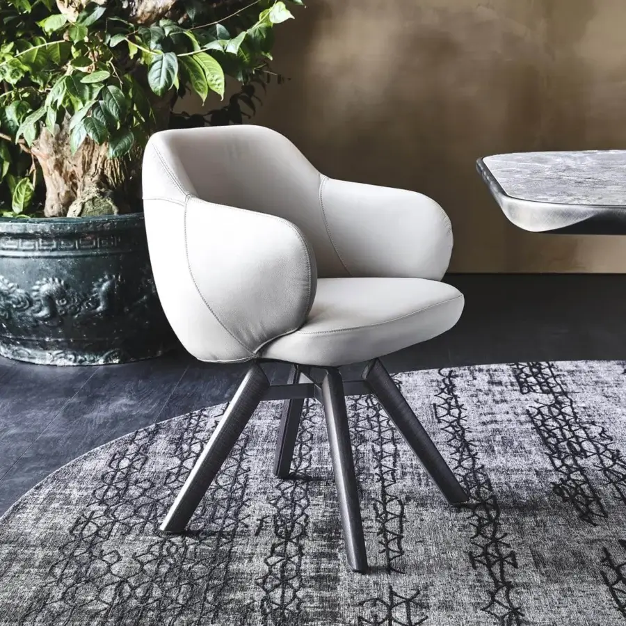 Stylish Cattelan Italia Bombè armchair with light beige soft leather upholstery and graphite lacquered steel base crafted with Canaletto walnut stained legs