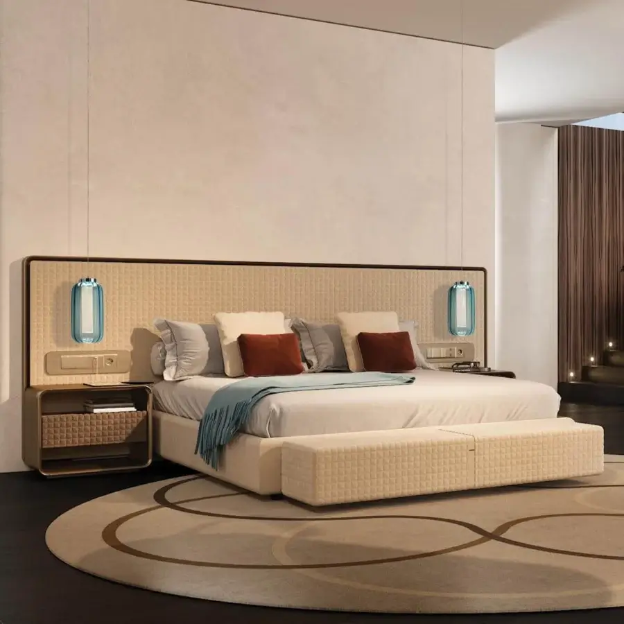 Distinguished Reflex Oh XL bed with woven beige upholstery, quilted headboard and bronze-finished details built with shaped wood and integrated lighting