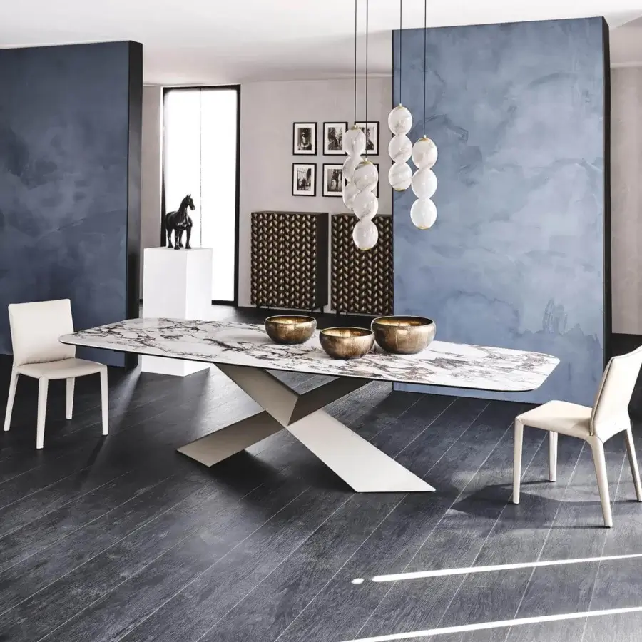 Sophisticated Cattelan Italia Tyron table with glossy Golden Calacatta ceramic top and light grey satin metal ‘X’ base