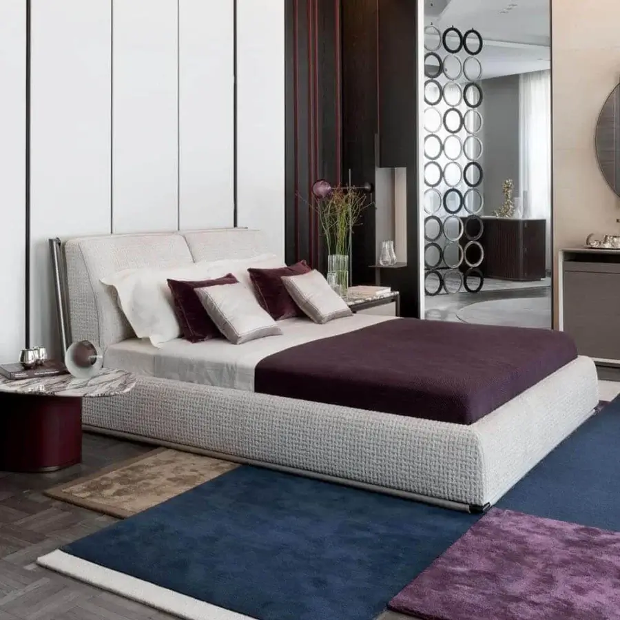 Superior Giorgetti Adam bed with light beige woven textile upholstery and cylindrical metal support legs