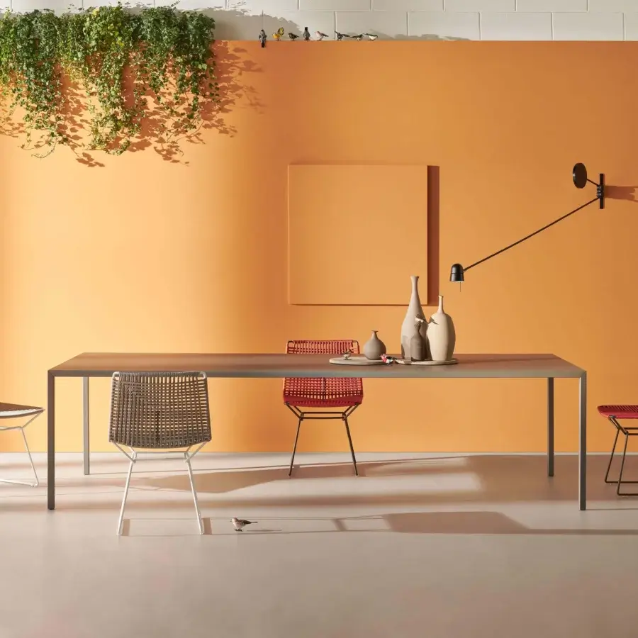 Distinguished MDF Italia Tense Outdoor table clad in aluminum sheet with a goffered painted neutral gray-brown finish exhibiting angular design