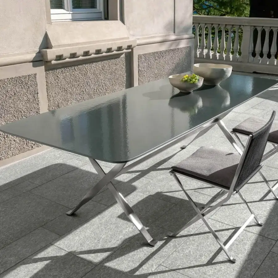 Exclusive Talenti George table with a dark gray lava stone top and geometric stainless steel base crafted in Italy