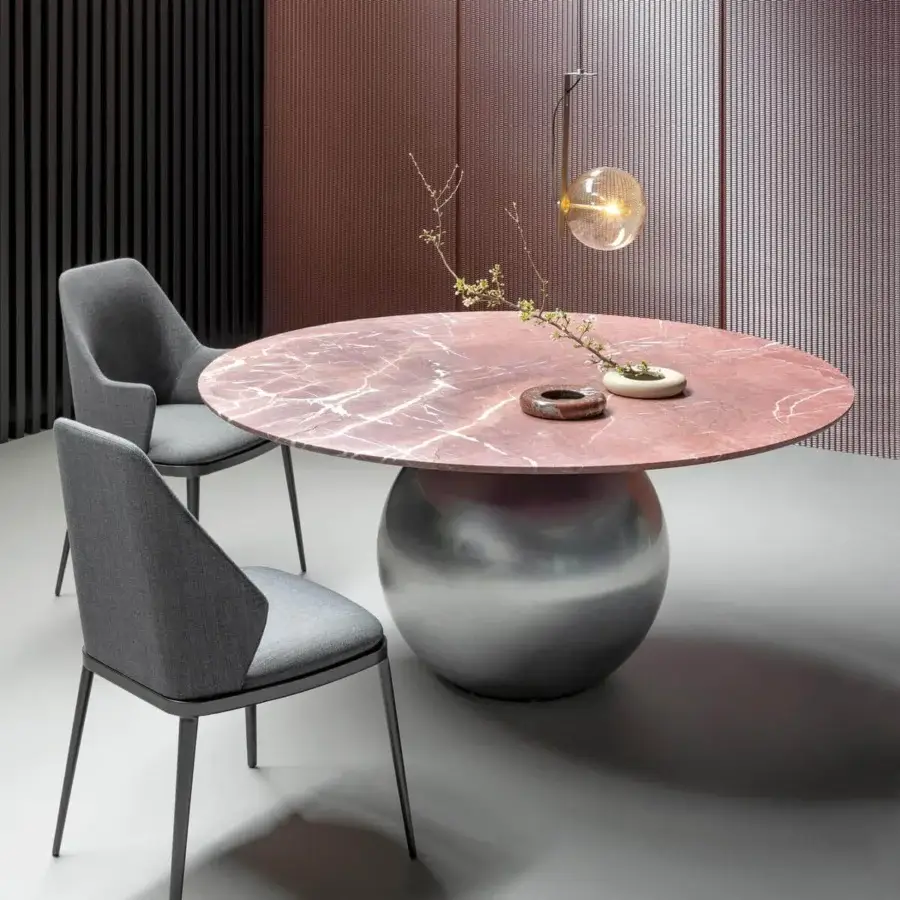 Elegant Bonaldo Circus table with a pinkish-red marble top and brushed metal base offering a balanced design