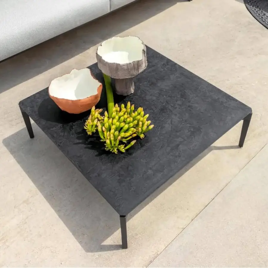 Innovative Talenti Leaf coffee table with aluminum base and vitter top in a dark gray textured finish