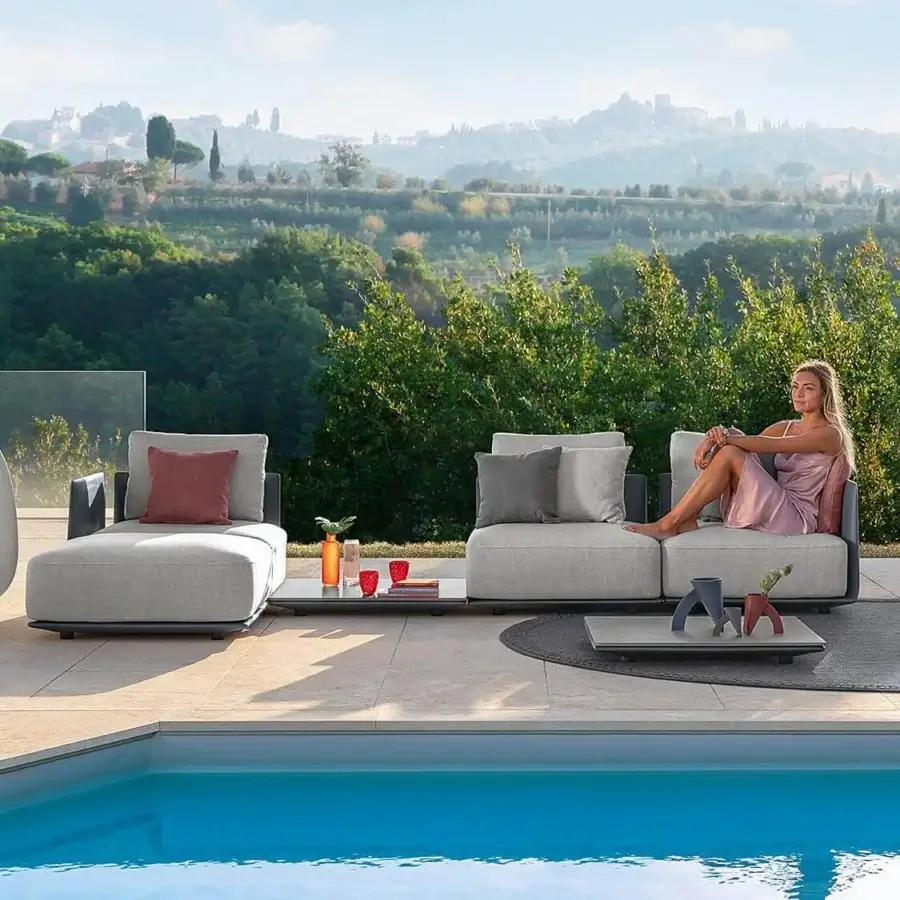 Distinguished Talenti Malè sectional with light grey polyethylene structure and reddish accent cushions for sophisticated outdoor relaxation