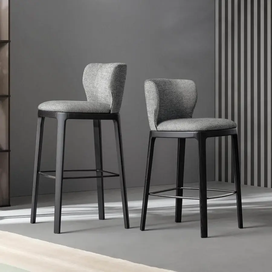 Distinguished Bonaldo Joy stool with solid wood base and light gray fabric seat, enhanced by a metal lead finish footrest