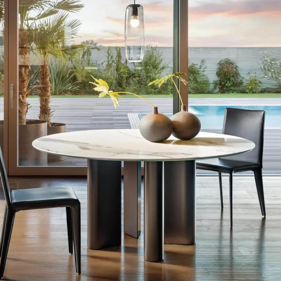 Innovative Bonaldo Geometric table with light cream marble-patterned ceramic top and dark metal teardrop legs
