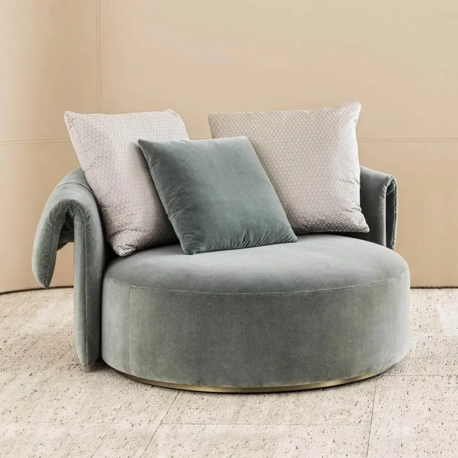 Lavish Rugiano Manta chaise lounge with rounded silhouette, plush gray-green textile and bronze plinth base