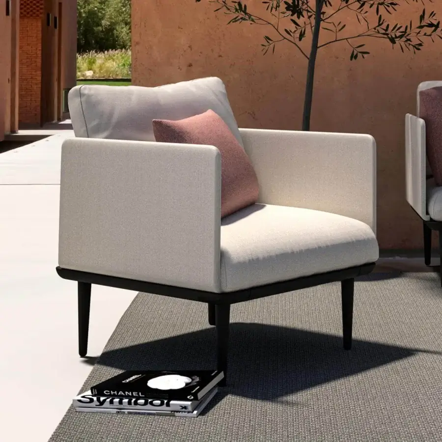 Sophisticated Royal Botania Styletto lounge chair with tapered coated aluminum legs and light beige fabrics with a pink cushion