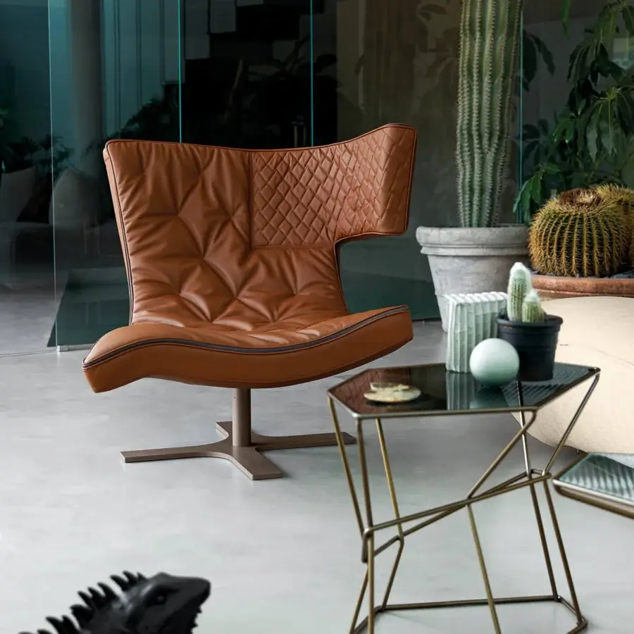 Lavish Arketipo Roxy lounge chair with sinuous shape and warm brown leather-like upholstery with a minimalist bronze finish