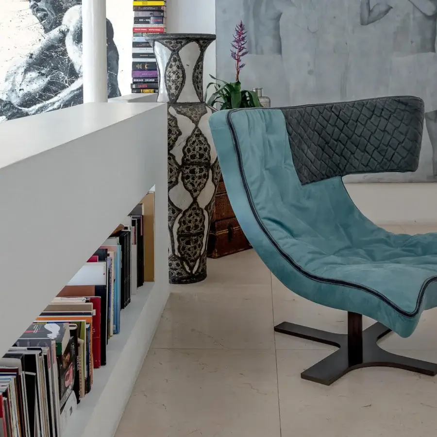 Distinguished Arketipo Roxy lounge chair in cool-toned blue textile with dark gray quilted headrest and sleek black piping