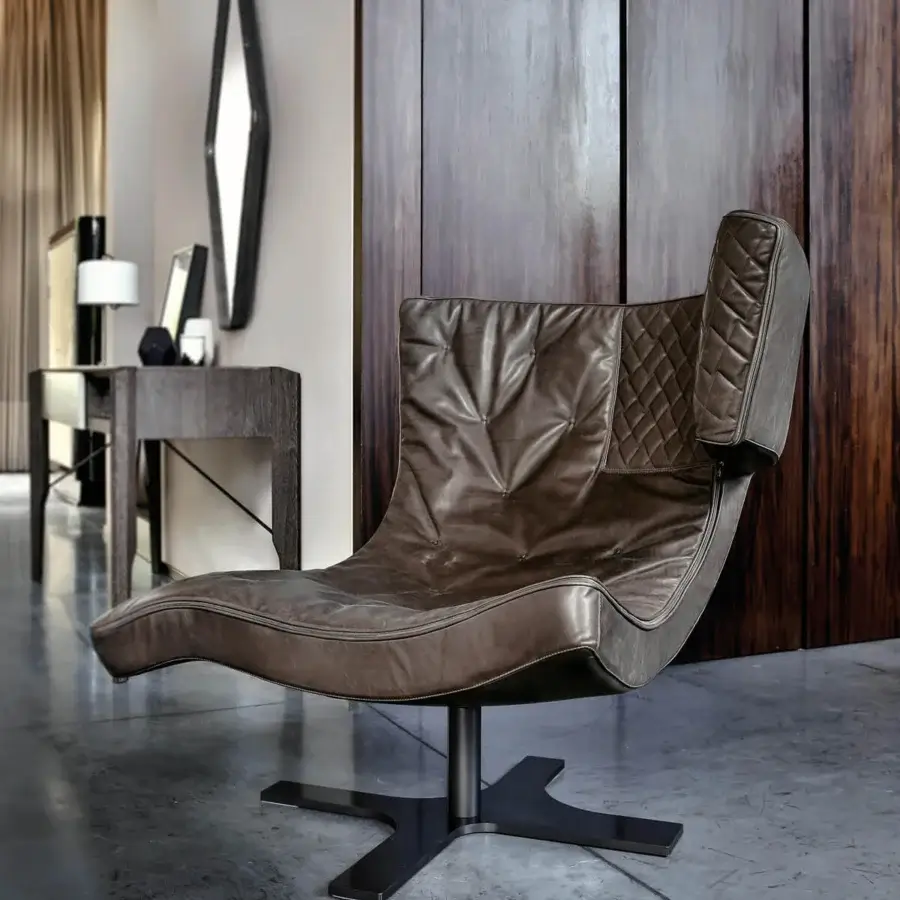 Lavish Arketipo Roxy lounge chair with sinuous silhouette and meticulous pinch-quilted brown leather upholstery crafted with a matte black metal base