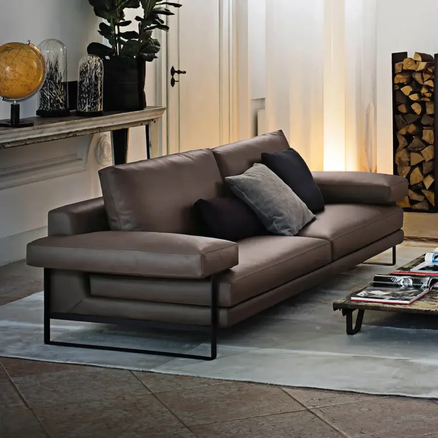 Exceptional Arketipo Ego sofa with carved geometric lines and smooth brown leather-like material, built with a black metal frame