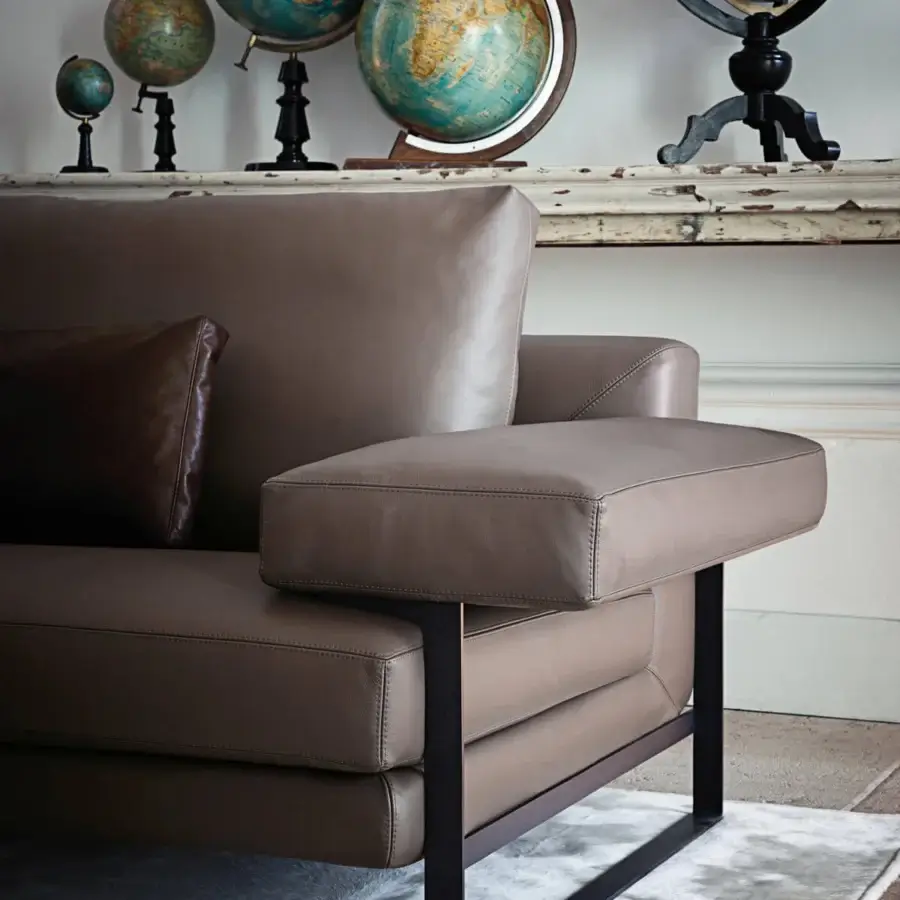 Distinguished Arketipo Ego sofa with geometric carving and taupe textile upholstery supported by micaceous brown stained metal feet