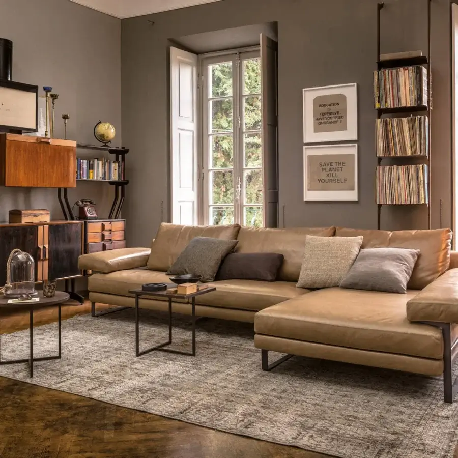 Superior Arketipo Ego sectional with carved geometric lines upholstered in light tan leather and dark metal legs