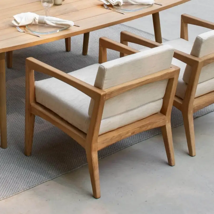 Elegant Royal Botania Zenhit armchair with light brown teak wood frame and light beige high-end fabric cushions