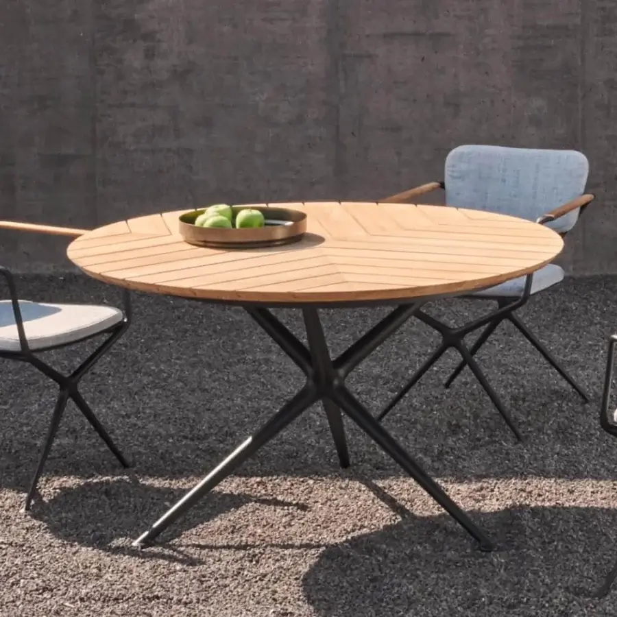 Distinguished Royal Botania Exes table with teak wood tabletop exhibiting a chevron pattern and sleek matte black coated aluminum legs