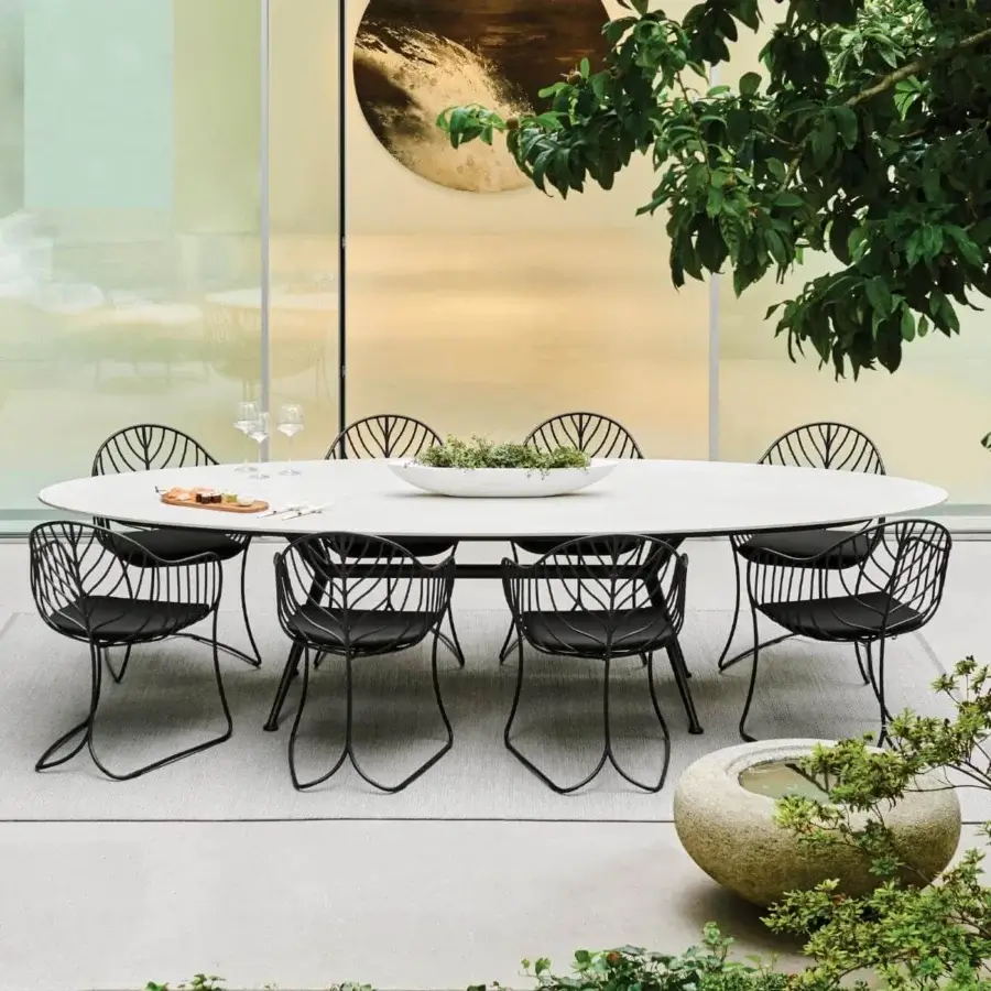 Distinguished Royal Botania Exes table with white ceramic tabletop and intersecting black coated aluminum legs in matte finish