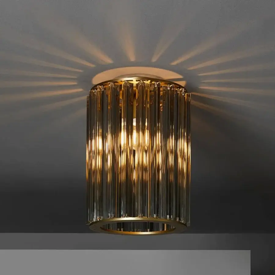 Refined VENICEM Crown ceiling lamp with light burnished brass structure and smoky translucent glass rods creating a warm ambience