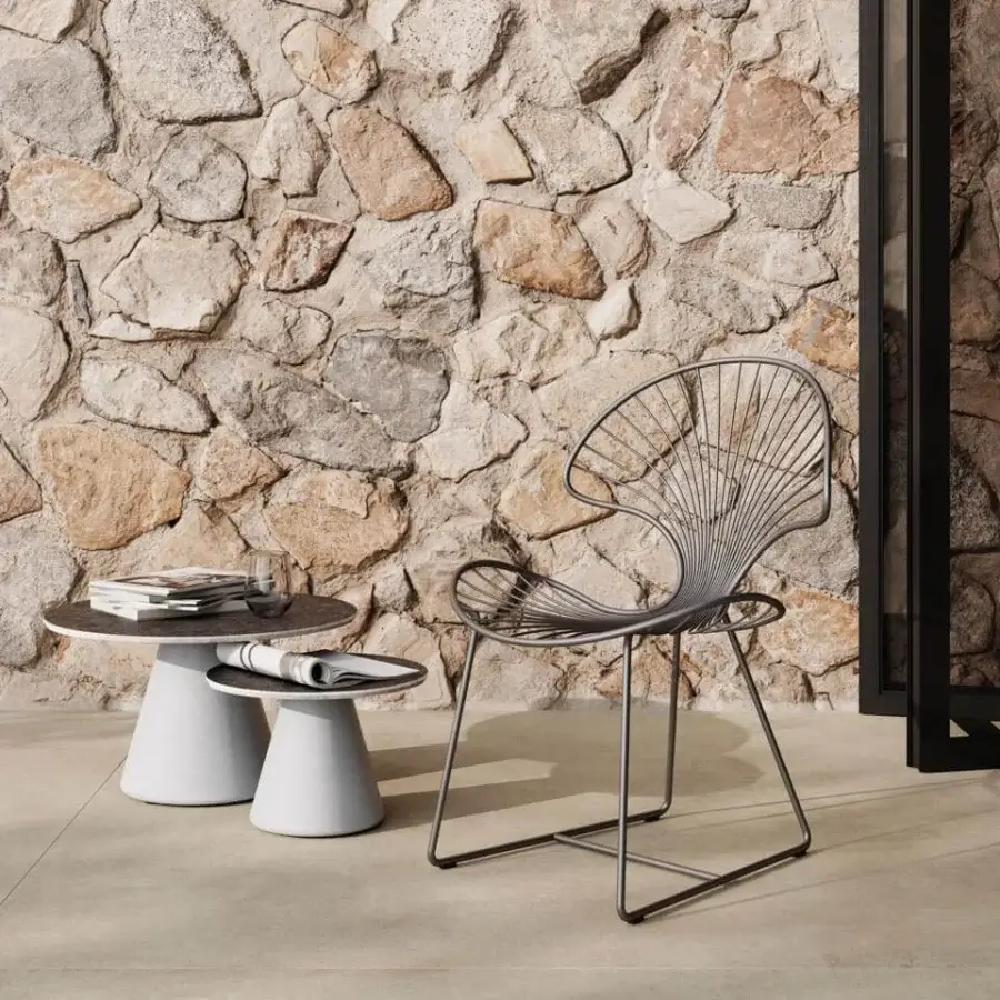 Comfortable Royal Botania Ostrea chair in dark gray coated stainless steel, with a curved silhouette and ergonomic design for outdoor dining