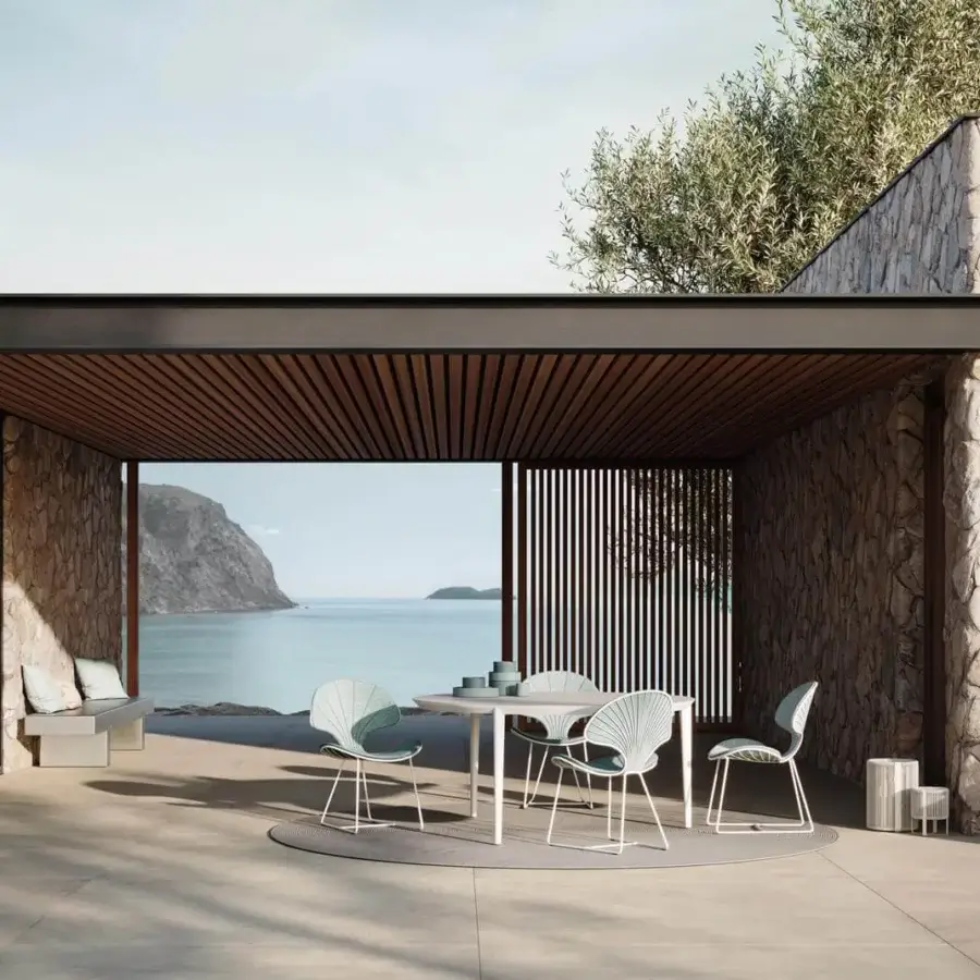 Inviting Royal Botania Ostrea chair with white metal frame and pale blue-green seat and backrest, designed for outdoor use and contemporary style