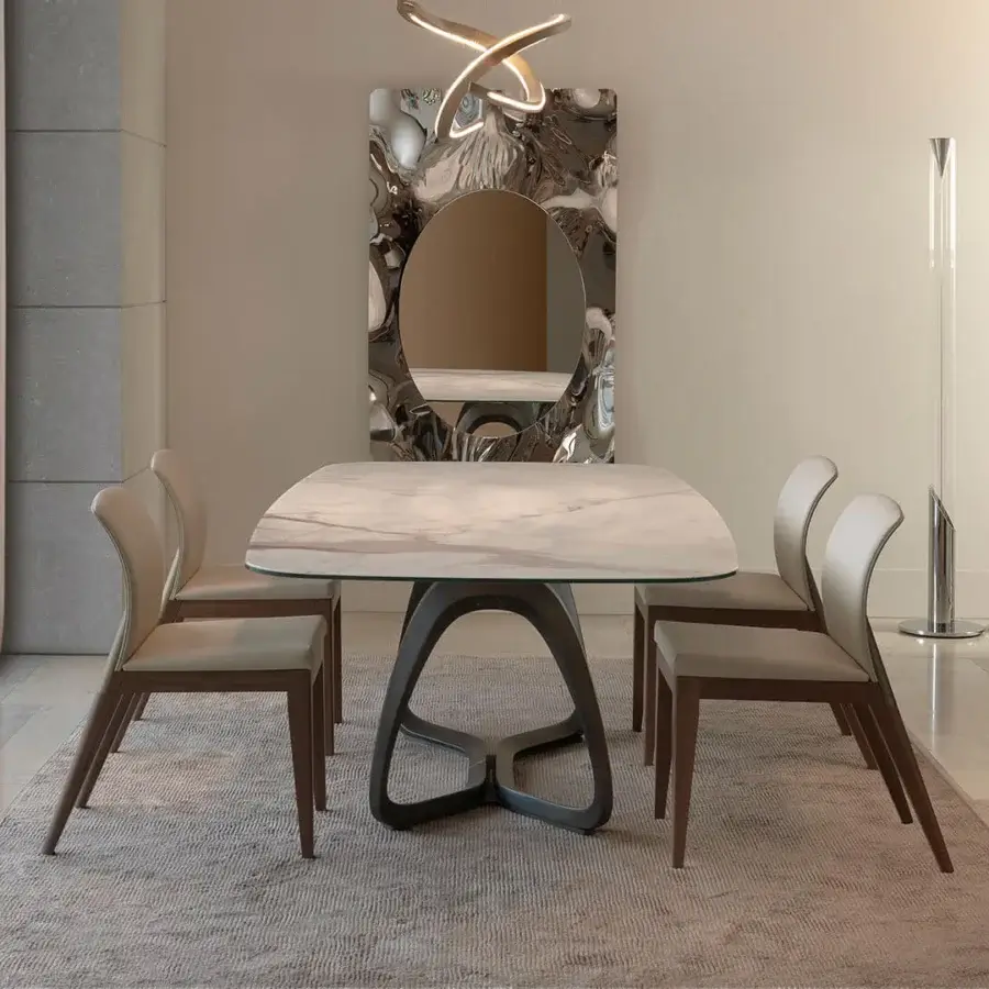 Luxury Reflex Segno table with a Marmoreflex top and dark brass composite material base crafted with curved supports