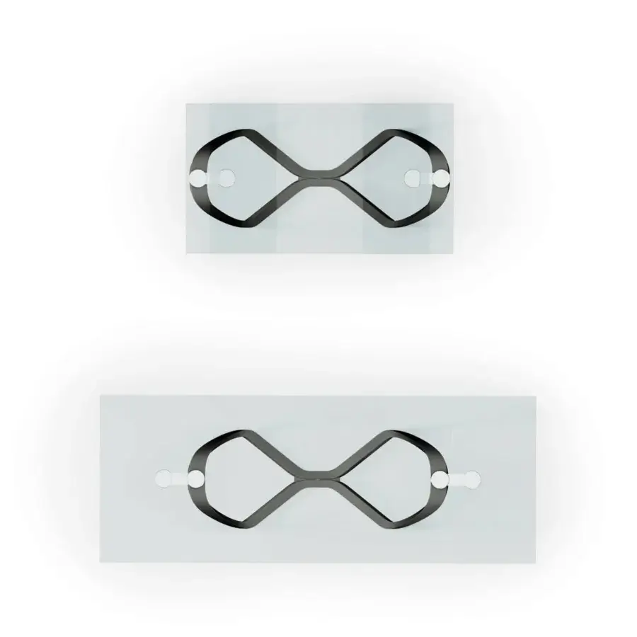 Distinguished Reflex Segno table with transparent glass top and sculptural bronze finish metal base forming an infinity symbol
