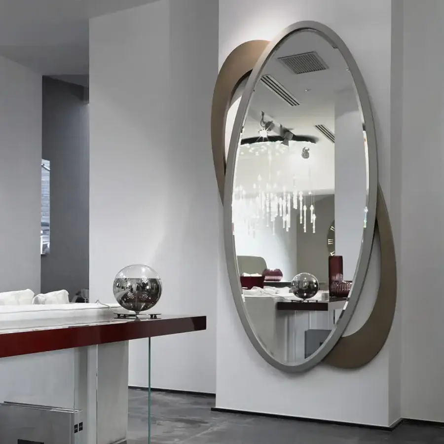 Superior Reflex Galassia mirror with extra clear glass, a light gray wooden frame and looping brass titanium band