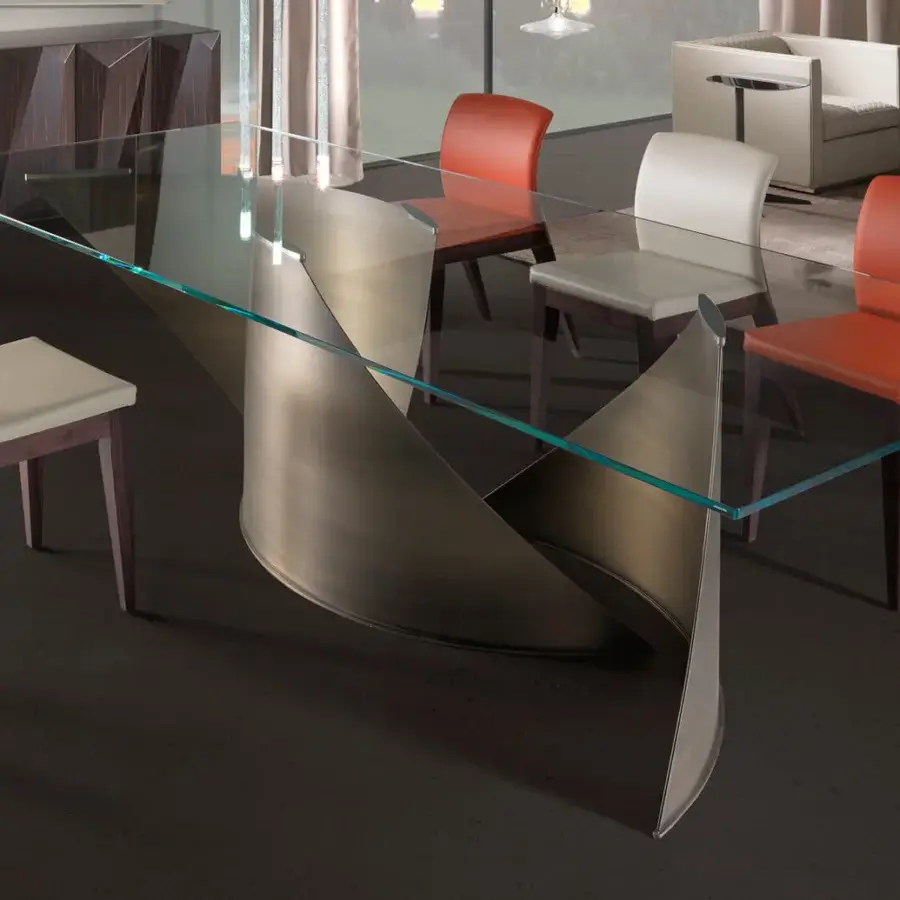 Distinguished Reflex Vele table with a sculpted titanium base and wide tempered glass top exhibiting a subtle green tint