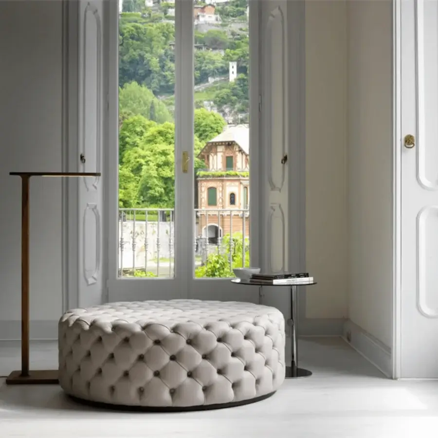 Lavish Porada Alcide ottoman with fully tufted light cream leather and dark accent band