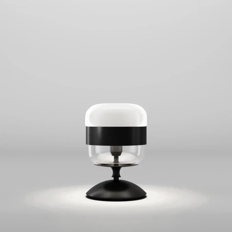 Superior Vistosi Futura table lamp crafted in blown glass with a transparent upper portion and diffused bottom with a sleek black metal ring and base