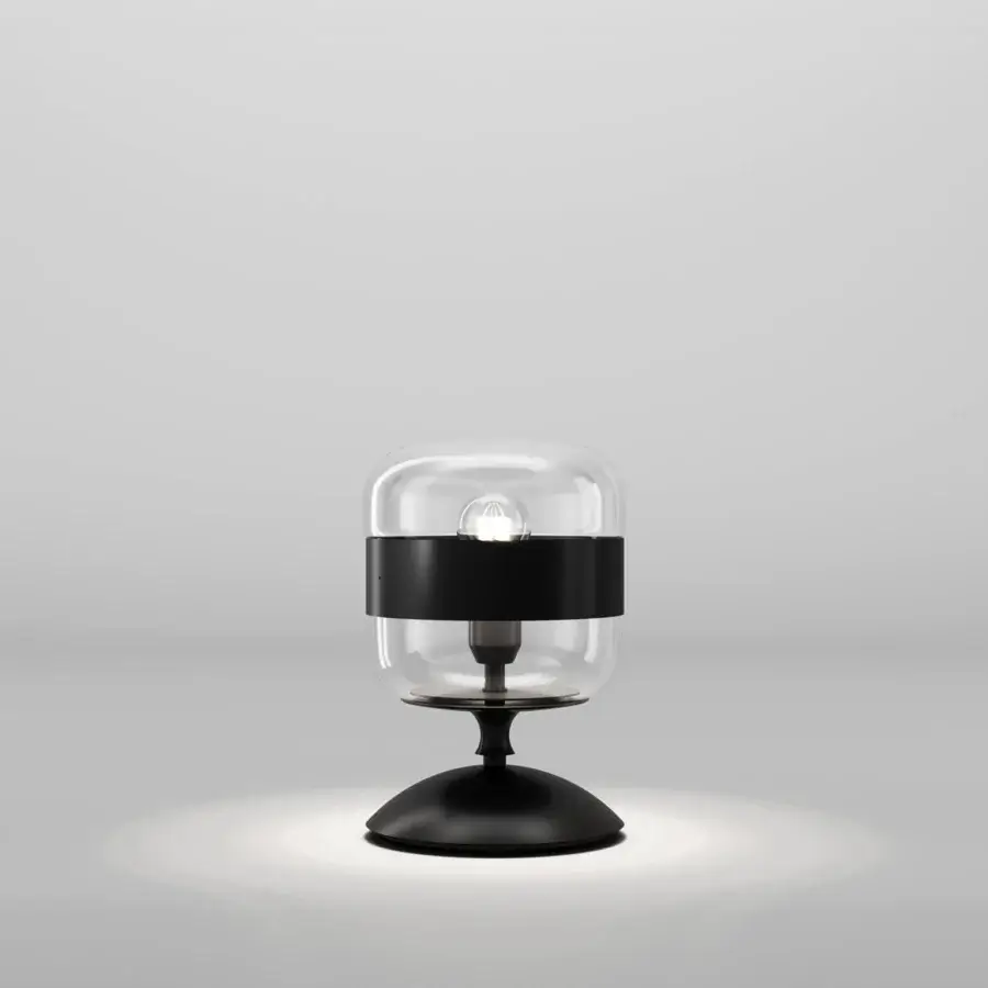Distinguished Vistosi Futura table lamp with a capsule-shaped blown glass body and matte black ring and base