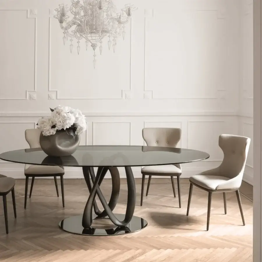 Distinguished Porada Andy chair with light textile upholstery and solid Canaletta Walnut frame exhibiting sleek curved lines