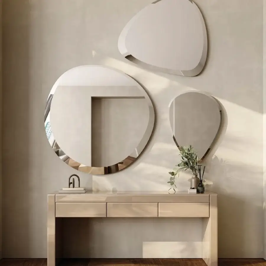 Distinguished Reflex Seventy mirror crafted from extra-clear glass with polished beveled edge and organic pebble-like form