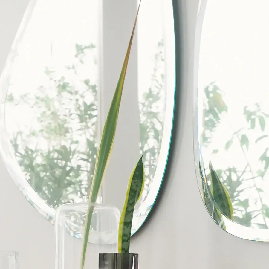 Distinguished Reflex Seventy mirror crafted from extra-clear glass with an irregular shape and smooth beveled edge