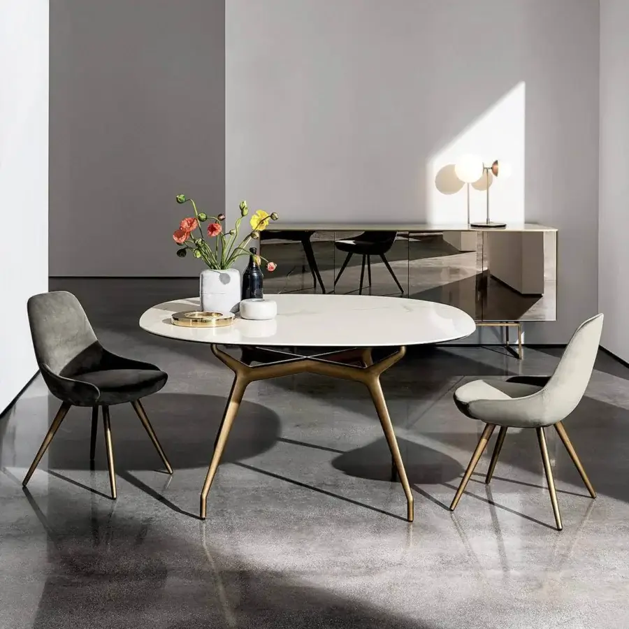 Cutting-edge Sovet Italia Arkos table with refined oval top and golden-bronze aluminum die-cast X legs