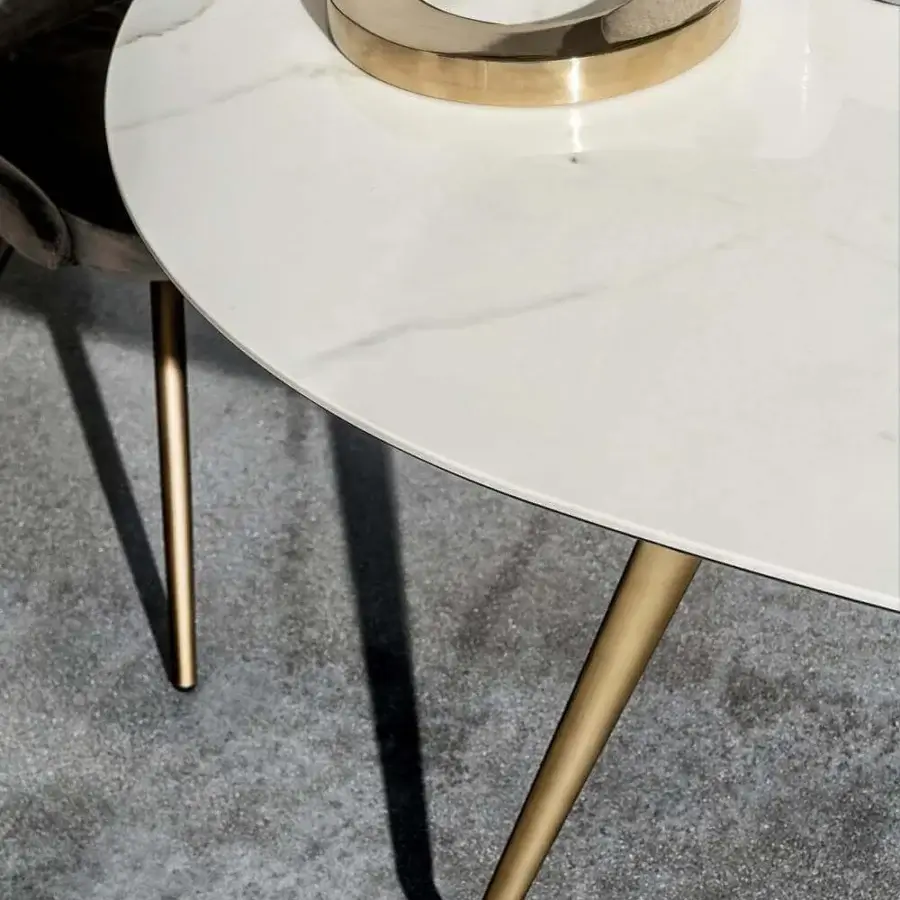 Elegant Sovet Italia Arkos table with smooth white marble-like top and glossy golden die-cast aluminum legs