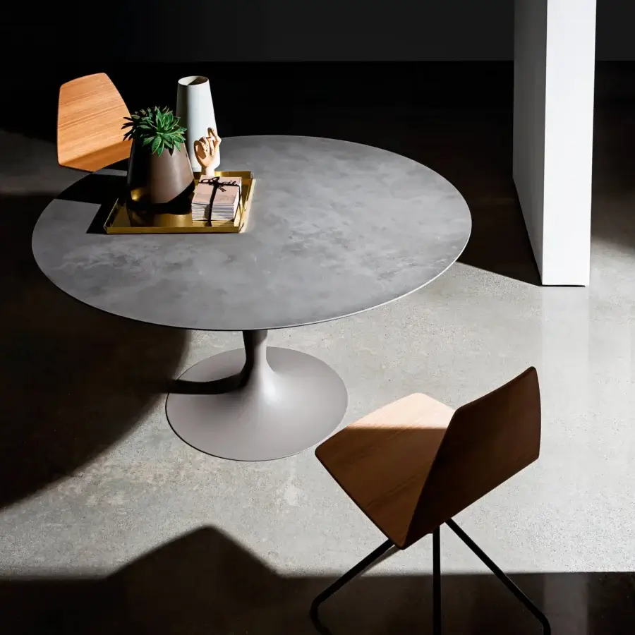 Sophisticated Sovet Italia Flute round table with smooth grey tempered glass tabletop and grey lacquered metal base