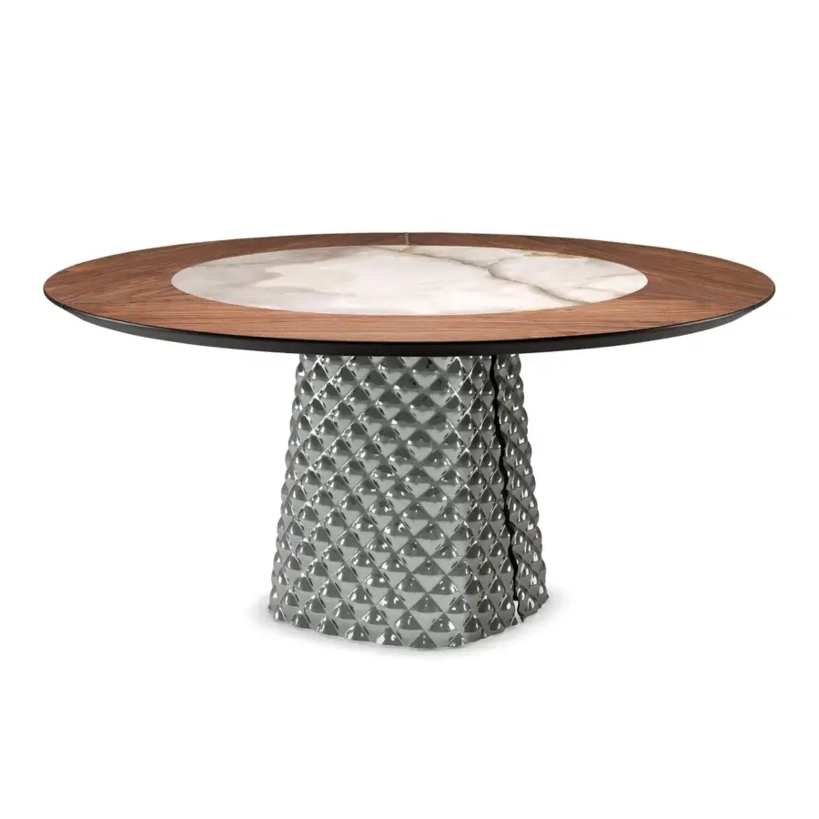 Dark and light circular disc rests on a gray textured column composed of small pyramidal shapes