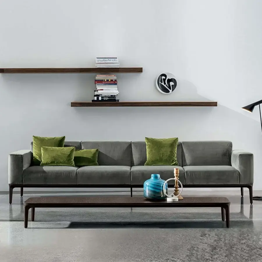 Superior Sovet Italia Slim sofa with polished chrome legs and muted grey European fabric upholstery complemented by textured green pillows